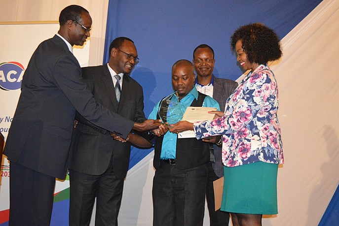 The KAM Chairlady Flora Mutahi (Right) receives a souvenir and letter of recognition from The Principal Secretary, State Department of Trade Dr. Chris Kiptoo (second left) and the Mr. Elema Halake, the Executive Director of the Anti-Counterfeit Agency (Left). Looking on is Mr. Joseph Wariuko, the KAM’s Executive Officer in charge of Counterfeiting and Illicit Trade and Dr. John Akoten the Deputy Director Research, Awareness and Policy from the Anti-Counterfeit Agency. Kenya Association of Manufacturers (KAM) Honored by ACA for Outstanding Support in Combating Counterfeiting